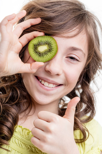 girl thumb up for kiwi green vitamins - Photo, Image