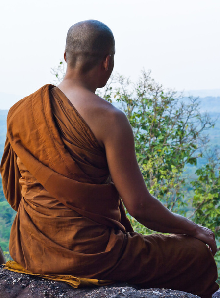 Monk meditating at the top of the mountain - Photo, Image