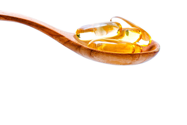Spoonful of gel capsules of omega 3. Close up capsules fish oil  - Photo, Image