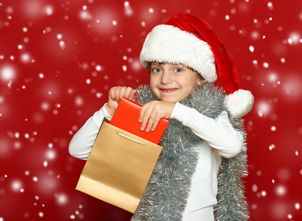 girl child portrait on red, winter holiday concept - Zdjęcie, obraz