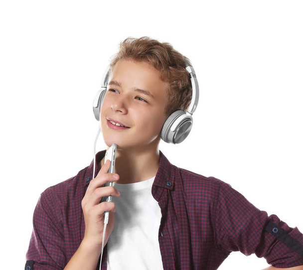Boy listening music on light background - Zdjęcie, obraz