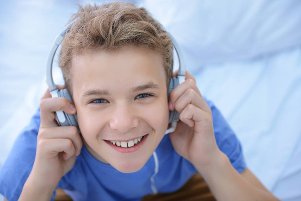 Boy listening music, closeup - 写真・画像