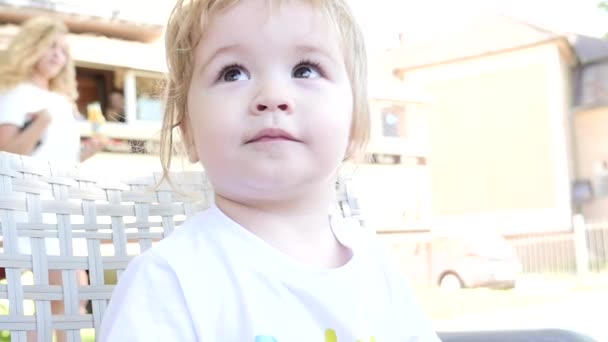Cute baby clapping hands and smiling outdoors slowmotion - Materiał filmowy, wideo