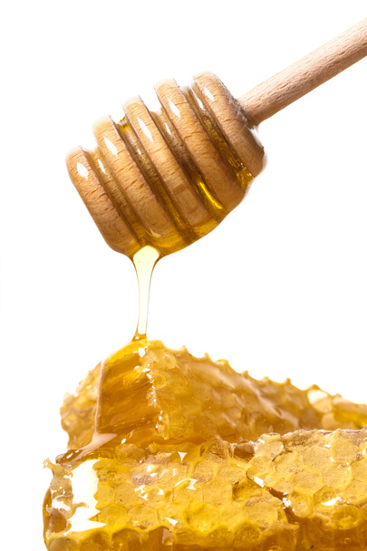 mel fluindo com uma colher
  - Foto, Imagem