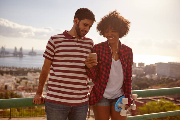 young couple with smartphone on bridge - Fotografie, Obrázek
