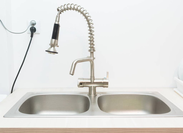 Close up of kitchen sink on white wall background. - Photo, Image