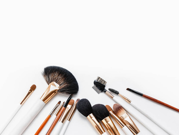 Set of flat top view of various professional female cosmetics brushes for makeup isolated on white background. - Photo, Image