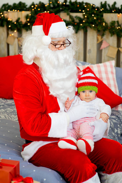 little baby in the arms of Santa Claus - 写真・画像