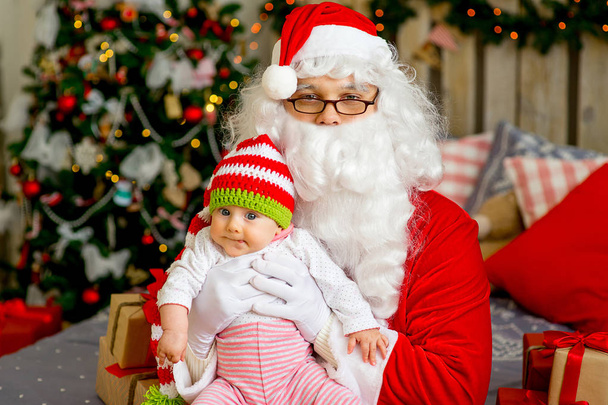 little baby in the arms of Santa Claus - Foto, immagini