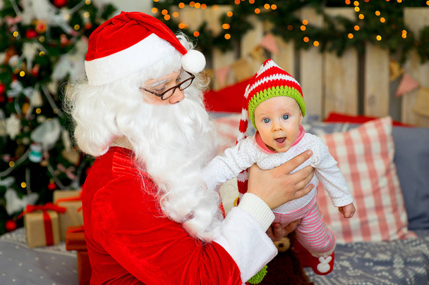 little baby in the arms of Santa Claus - Valokuva, kuva