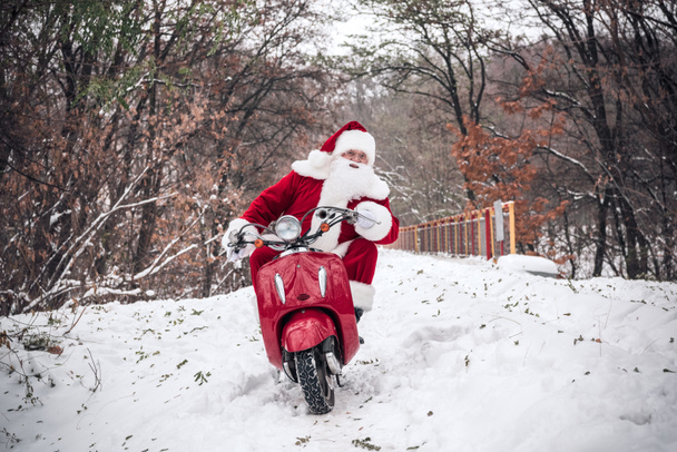 Santa Claus riding on scooter - Valokuva, kuva