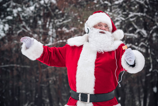 Santa Claus dancing in headphones    - Zdjęcie, obraz