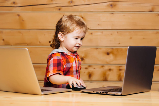 Cute boy plays on computers - Фото, изображение