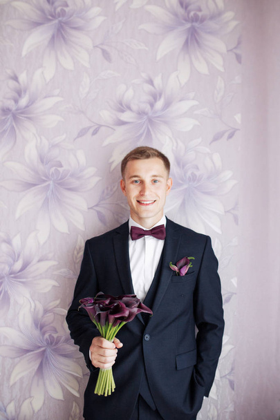 Gorgeous smiling groom. Handsome groom at wedding tuxedo smiling and waiting for bride.Elegant man in black costume and bow-tie. - Φωτογραφία, εικόνα