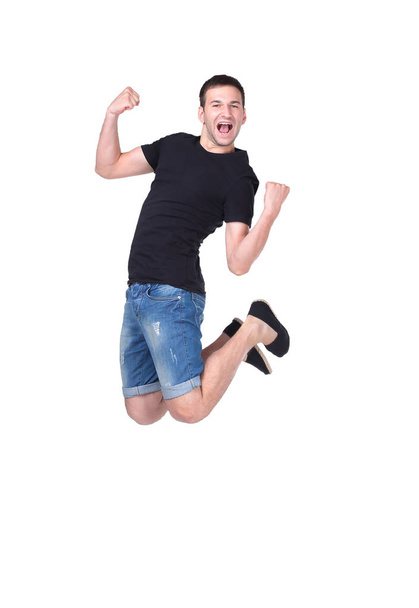 Jumping young man. Isolated over white background - Фото, зображення