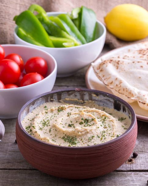 Humus in homemade bowl chapati and vegetable. - Photo, Image