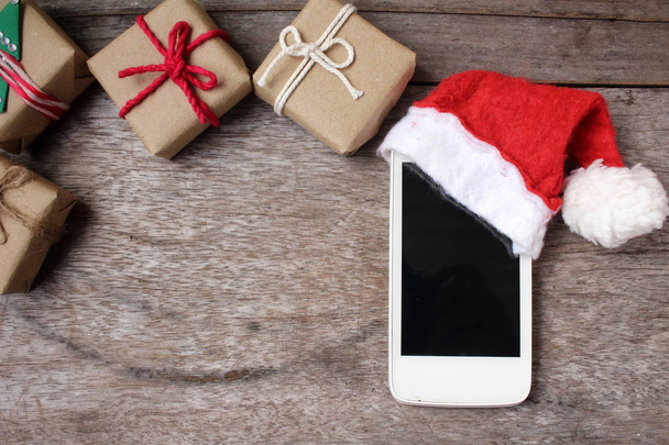 Smart phone with christmas hat - Фото, изображение