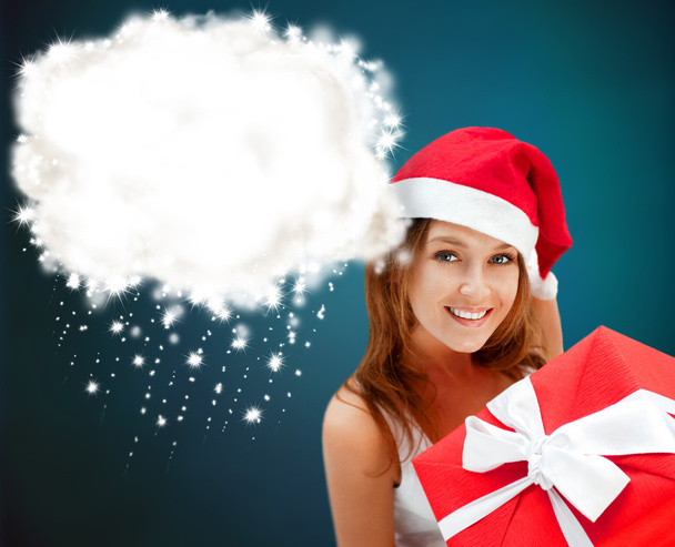 Young happy girl in Christmas hat. Holding huge christmas gift. - Foto, Imagem