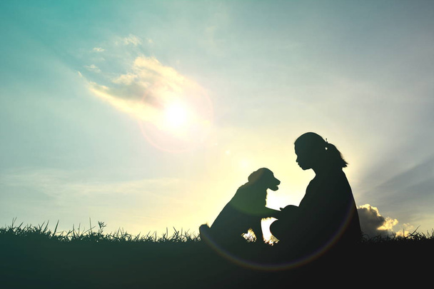 Silhouette women playing with dog  - 写真・画像
