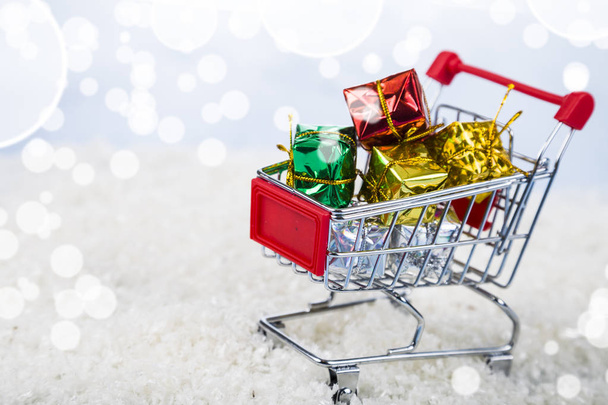 Shopping carts with Christmas gifts in the snow. Concept of Chri - Fotoğraf, Görsel