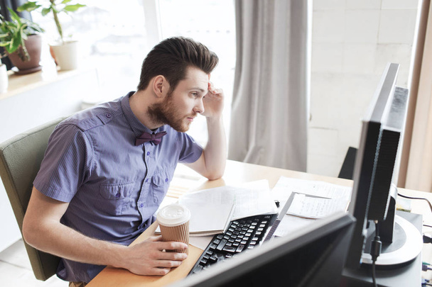 creative male worker with computer drinking coffee - Фото, зображення