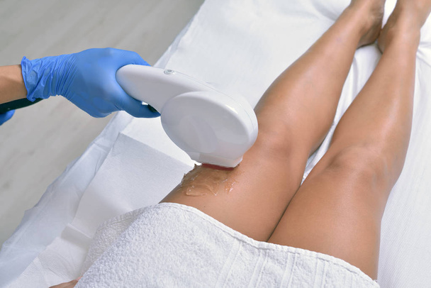 Mulher recebendo pernas tratamento a laser de pele em um salão de beleza, close-up
 - Foto, Imagem