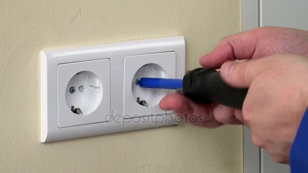 male hands with screwdriver repairing electrical outlet - Footage, Video