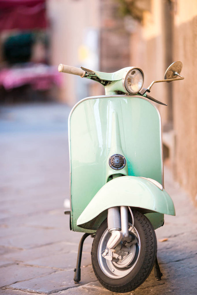 Light blue scooter on the street of the old city. Old classic european city elements - Φωτογραφία, εικόνα