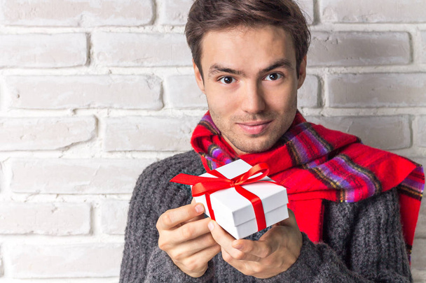 Handsome Guy Gives a New Year Gift - Foto, Imagen