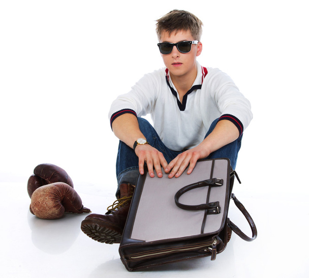 Portrait of sleazy young man posing on white background with bag - Foto, immagini