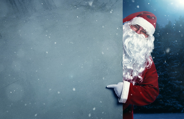 Babbo Natale che punta sul banner vuoto
 - Foto, immagini