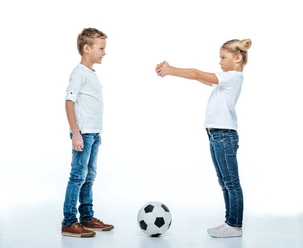 Siblings standing with soccer ball  - Fotografie, Obrázek