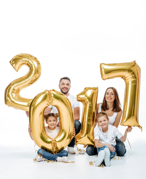 Happy family holding golden balloons  - Фото, зображення