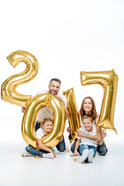 Happy family holding golden balloons  - Fotó, kép