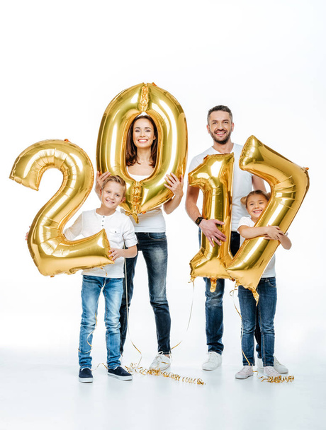 Happy family holding golden balloons  - Zdjęcie, obraz