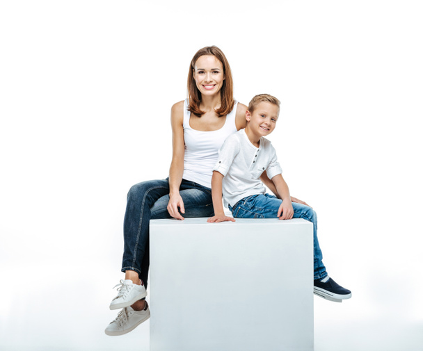 Smiling mother with son sitting togethe - Фото, изображение