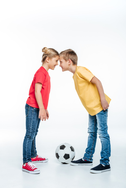 siblings standing with soccer ball - Фото, зображення