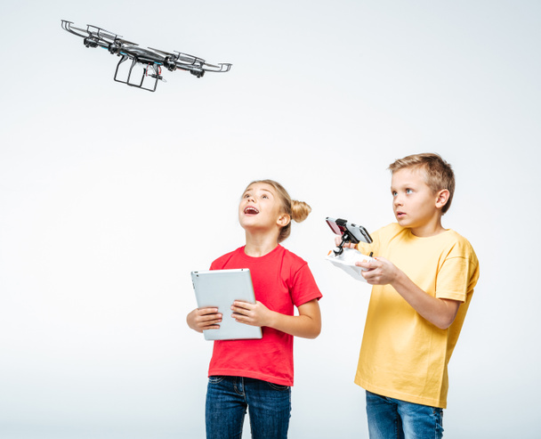 Kids using digital tablet and hexacopter drone - Фото, изображение