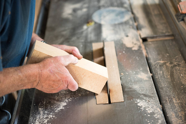 Carpenter's hands working wood in his workshop - Фото, изображение