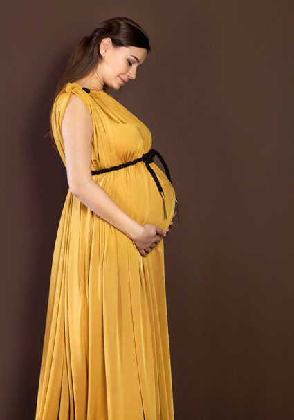 Happy pregnant woman touching her belly - 写真・画像