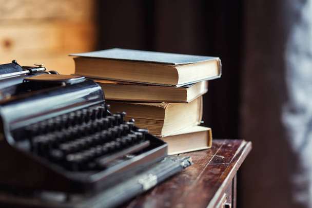 typewriter and books on the table, vintage typewriter and old books, vintage,writer Area, typewriter, old typewriter with blank paper on wooden desk, old typewriter keys, antique, retro - Photo, Image