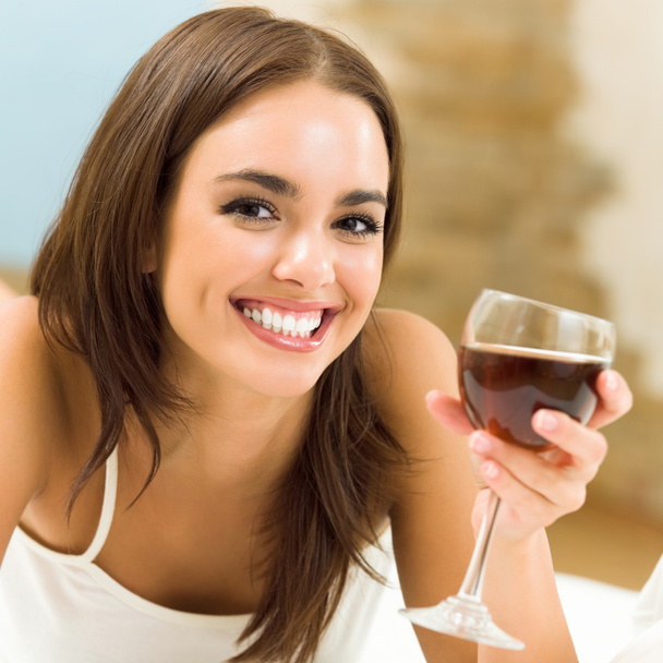 Young woman with glass of redwine - Photo, image