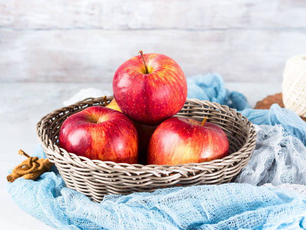 Fresh apples in basket on napkins. Healthy eating - Fotó, kép