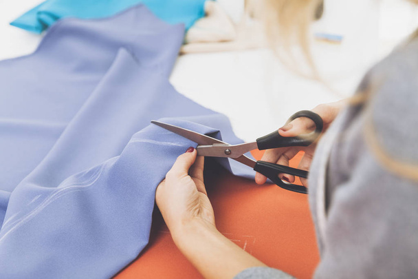 Close up of woman cutting blue material - Photo, Image