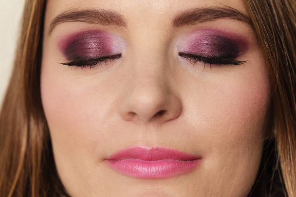 Woman closed eyes with violet dark shadows makeup  - Photo, Image