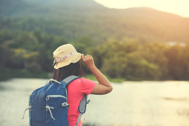  woman with backpacks still looking at the beautiful of landscape happily - Фото, зображення