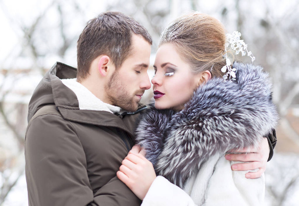 Young beautiful couple, guy and girl, embraces, love and winter - Photo, Image