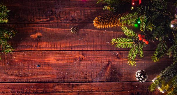 Top view on a wooden background with Christmas decorations - Photo, Image