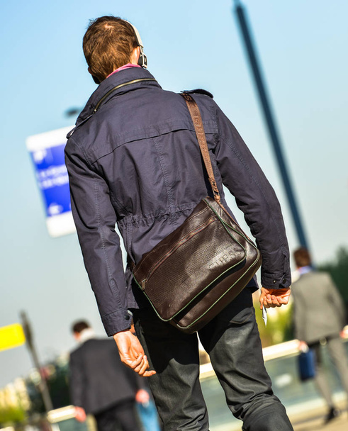 La defense, France- April 10, 2014: back view of businessman walking in a street. He wears shoulder strap bag - Photo, Image