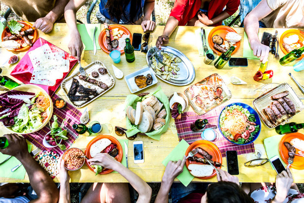 Friends eating and drinking at picnic - 写真・画像
